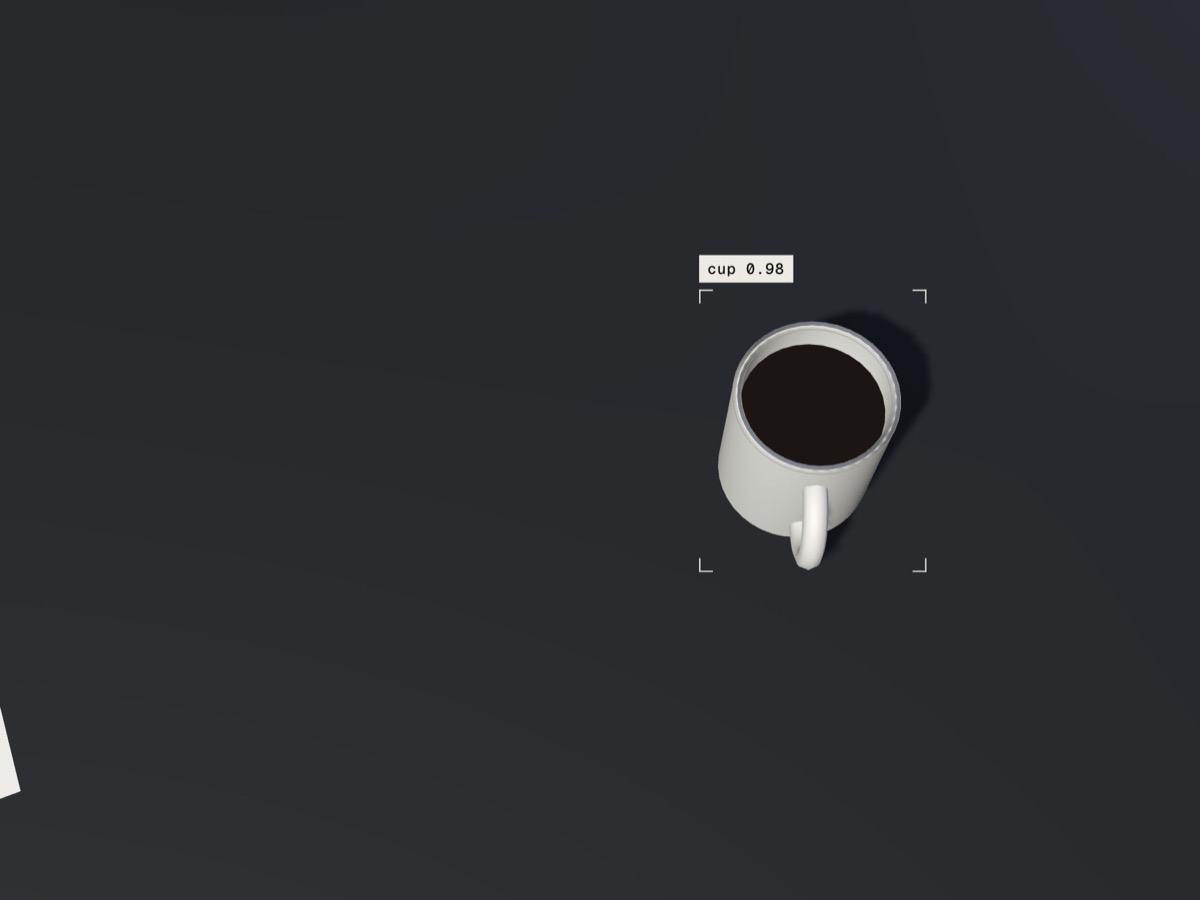 The robot's camera view: a cup on a counter, boxed and labeled as a cup.